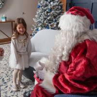 Girls smile talking with Santa